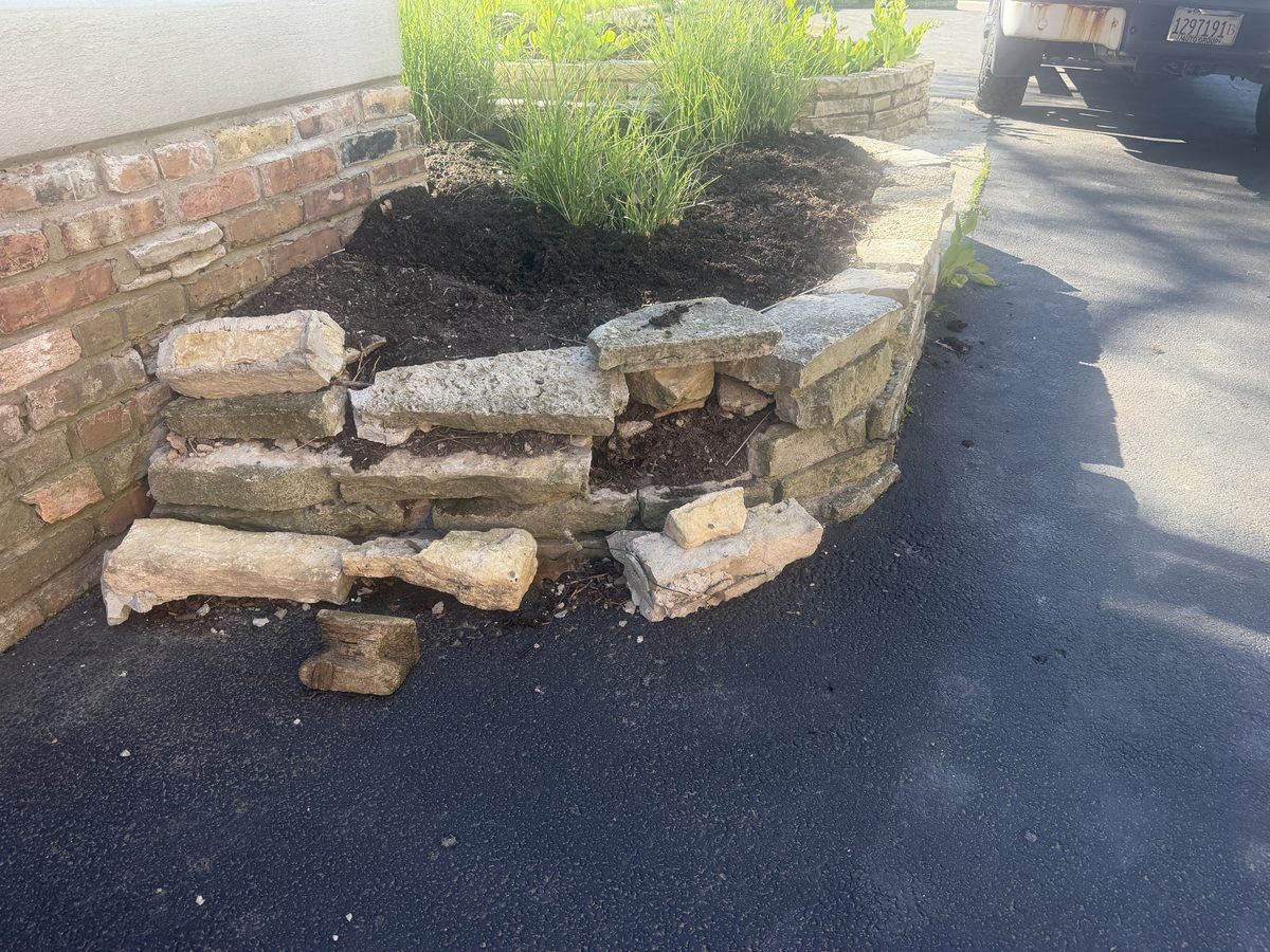 Before — collapsed stone retaining wall