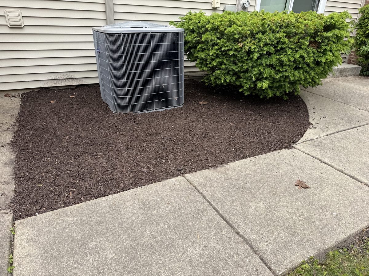 Mulch installation along house