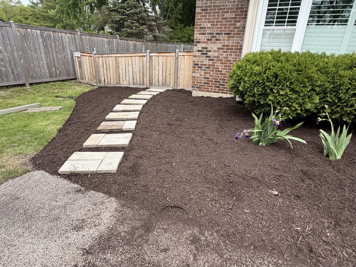 After — fresh mulch and stepping stones